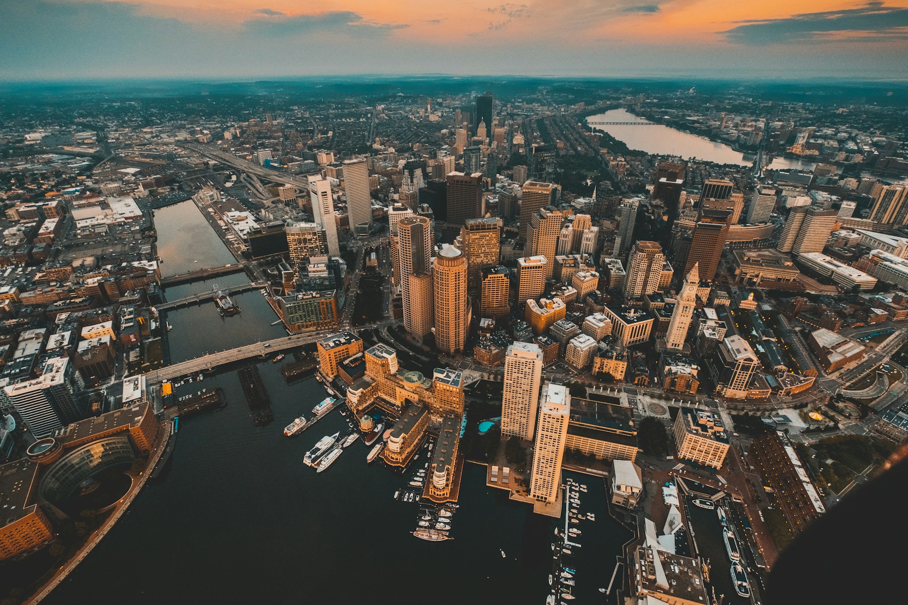 An aerial view of Boston’s waterfront and downtown at sunset